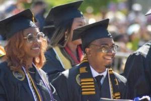 two students smiling at graduation